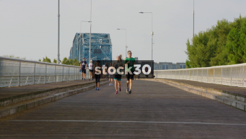 Slow Motion Shot Of People Jogging And Walking On Walnut Street Bridge In Chattanooga, Tennessee, USA
