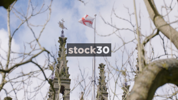 Slow Motion Shot Of The St George Flag On Top Of St Mary's Church In Warwick, UK