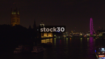 The River Thames, London Eye And Houses Of Parliament In London At Night, UK