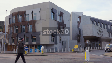 The Scottish Parliament Building With Traffic Passing By In Holyrood, Edinburgh, UK