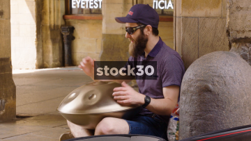 Man Playing A Handpan Percussion Instrument On Guildhall Street In Lincoln, UK