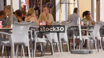 Close Up Of People Dining Outside Restaurant On Street In Valencia, Spain